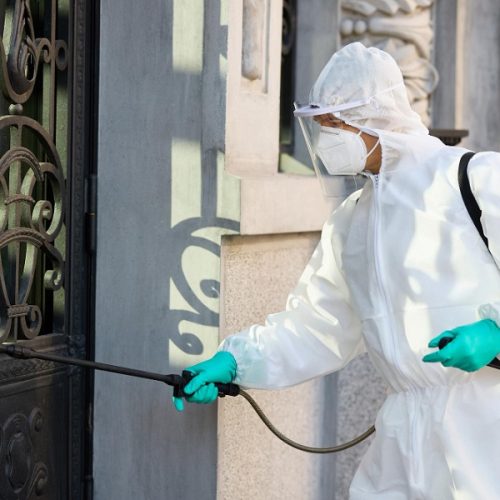 healthcare worker disinfecting contaminated city area due coronavirus pandemic