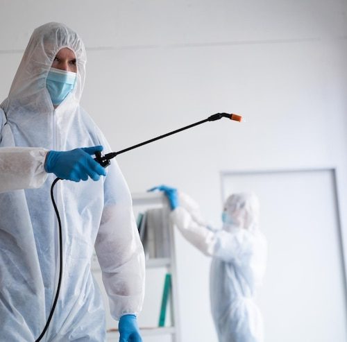 caucasian male doctor scientist wearing protective clothing face mask cleaning spraying disinfectant all place coronavirus covid 19 pandemic biohazard 13339 318265